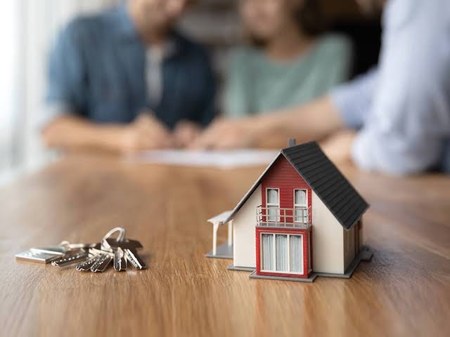 A couple reviewing documents with their financial advisor